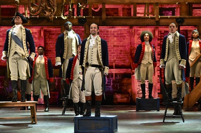 Lin-Manuel Miranda (center) and the company of 'Hamilton' performs onstage during the 70th Annual Tony Awards at The Beacon Theatre.